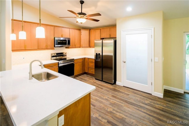 kitchen with pendant lighting, sink, ceiling fan, kitchen peninsula, and stainless steel appliances