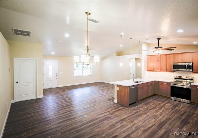 kitchen with sink, ceiling fan with notable chandelier, stainless steel appliances, and lofted ceiling