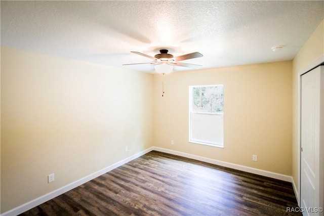 interior space with a textured ceiling, dark hardwood / wood-style flooring, and ceiling fan