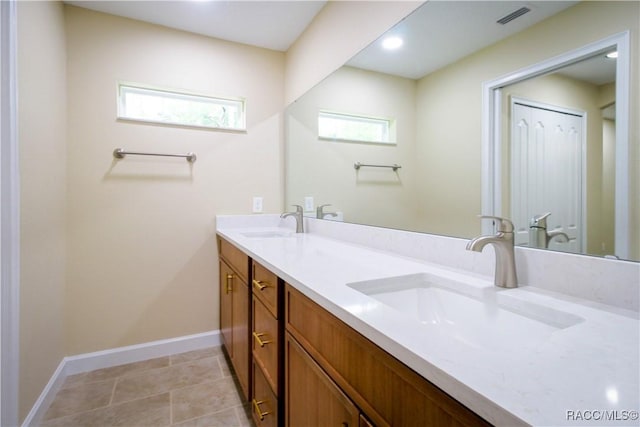 bathroom with tile patterned floors and vanity