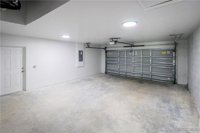 garage featuring electric panel and a garage door opener