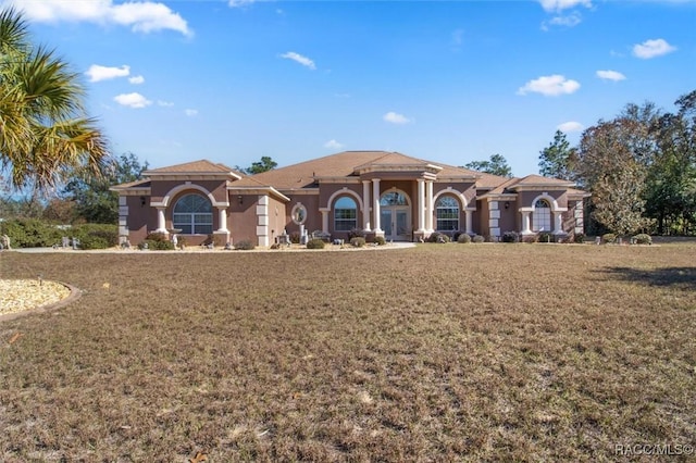 mediterranean / spanish-style house with a front yard