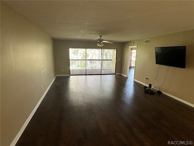 unfurnished living room featuring a textured ceiling, dark hardwood / wood-style floors, and ceiling fan