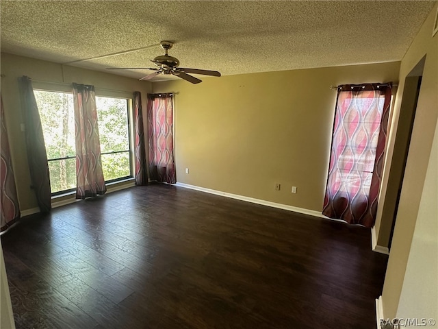 unfurnished room featuring a textured ceiling, dark hardwood / wood-style floors, and ceiling fan