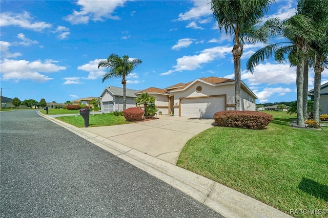 view of front of home with a front yard and a garage