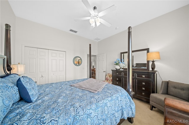 bedroom with ceiling fan, light carpet, and a closet