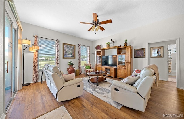 living room featuring light hardwood / wood-style floors and ceiling fan