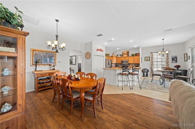 dining room featuring a notable chandelier and light wood-type flooring