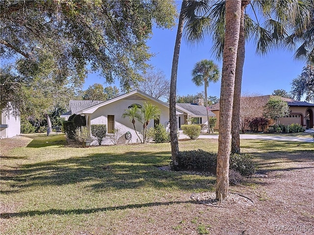 single story home featuring a front lawn