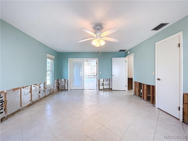 unfurnished room with light tile patterned floors and ceiling fan