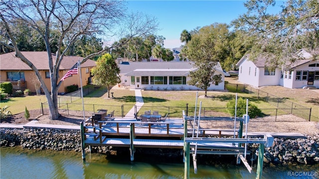 dock area featuring a water view and a yard