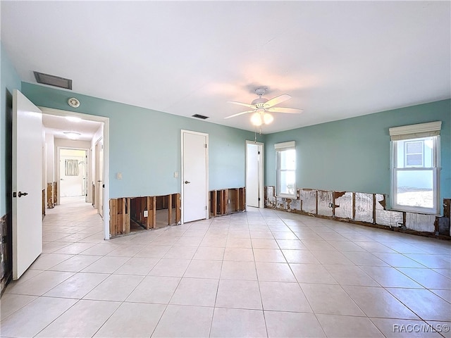 tiled empty room with ceiling fan