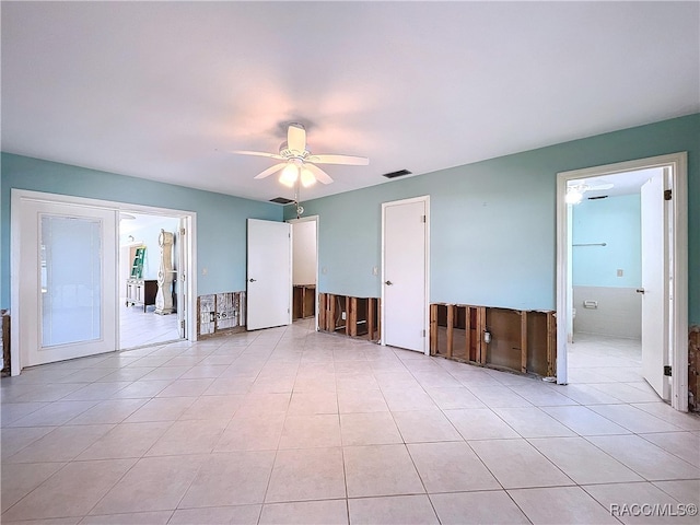 tiled spare room with ceiling fan