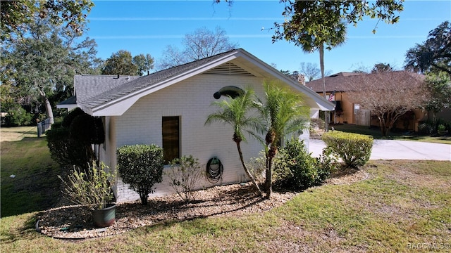 view of side of home featuring a yard