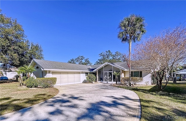 single story home featuring a garage and a front lawn