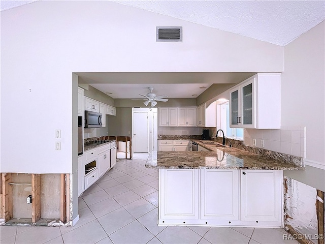 kitchen with sink, light tile patterned floors, ceiling fan, white cabinets, and kitchen peninsula