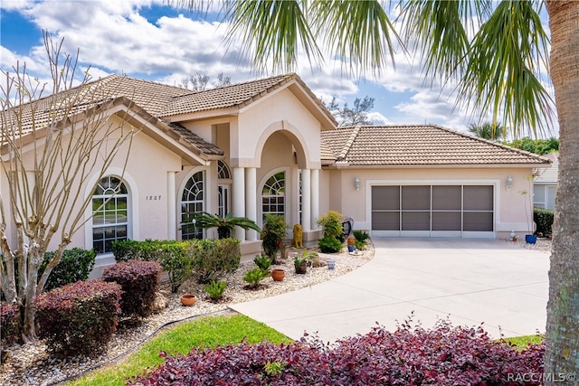 mediterranean / spanish-style home featuring a garage