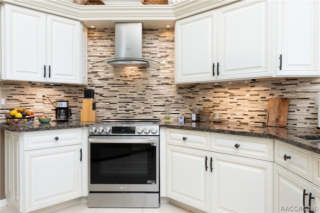 kitchen featuring electric range, tasteful backsplash, white cabinetry, and wall chimney range hood