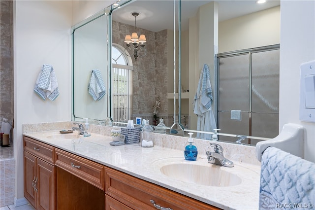 bathroom with vanity, tile patterned floors, walk in shower, and a notable chandelier