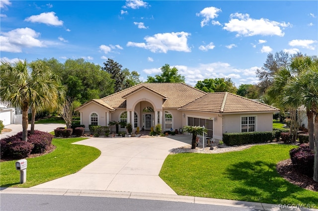 mediterranean / spanish-style home featuring a front lawn