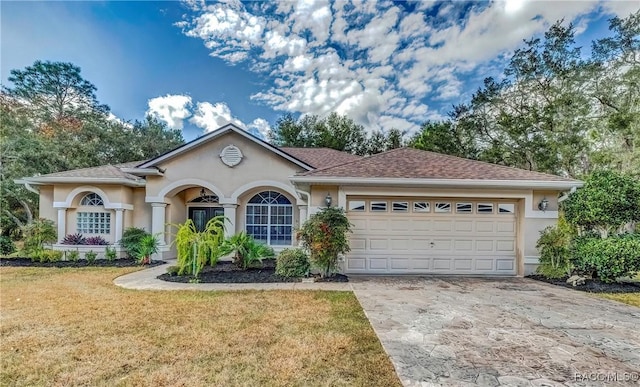 single story home with a front yard and a garage