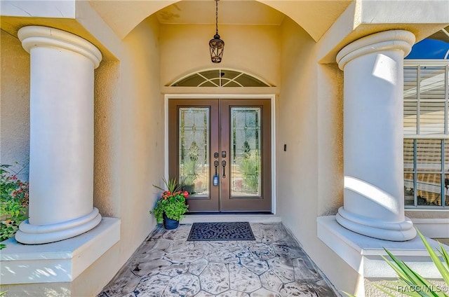 property entrance featuring french doors and stucco siding