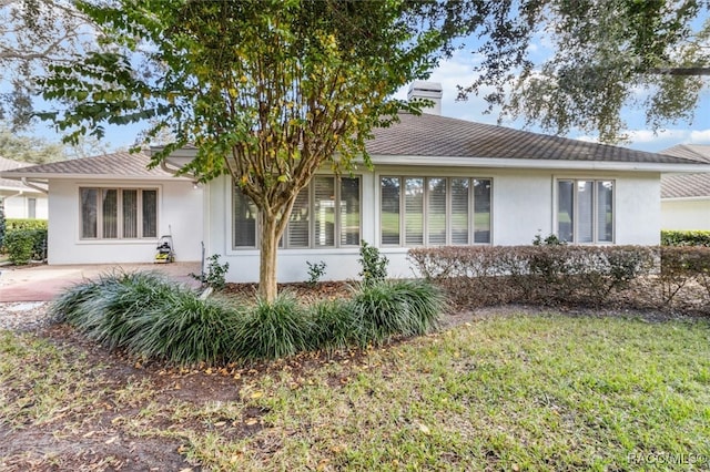 rear view of house featuring a yard