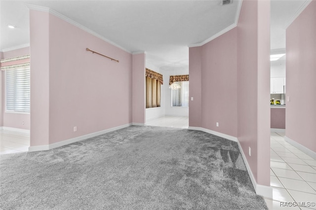 unfurnished room with light carpet, plenty of natural light, a notable chandelier, and ornamental molding