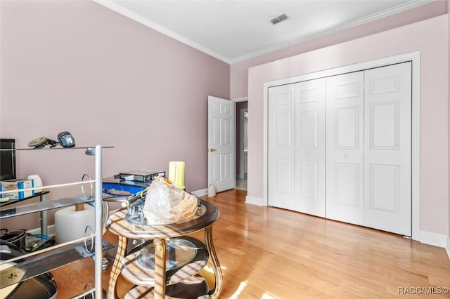 office featuring light wood-type flooring and ornamental molding