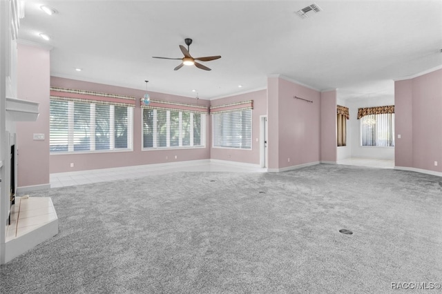 unfurnished living room with ceiling fan, light colored carpet, and crown molding