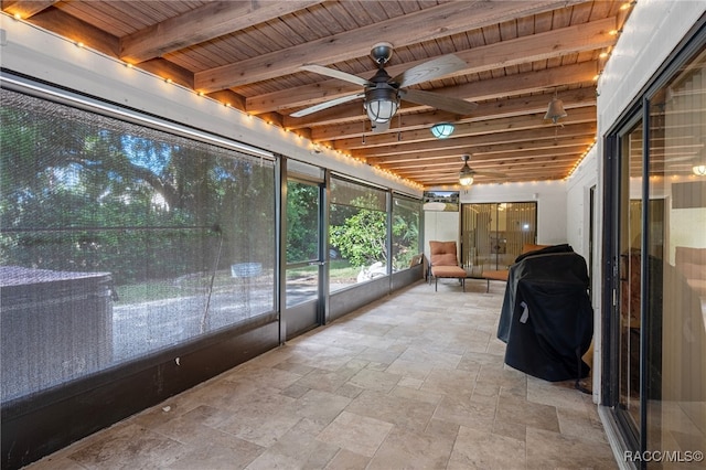 unfurnished sunroom with ceiling fan, beamed ceiling, and wooden ceiling