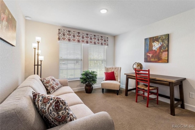 carpeted living room featuring baseboards