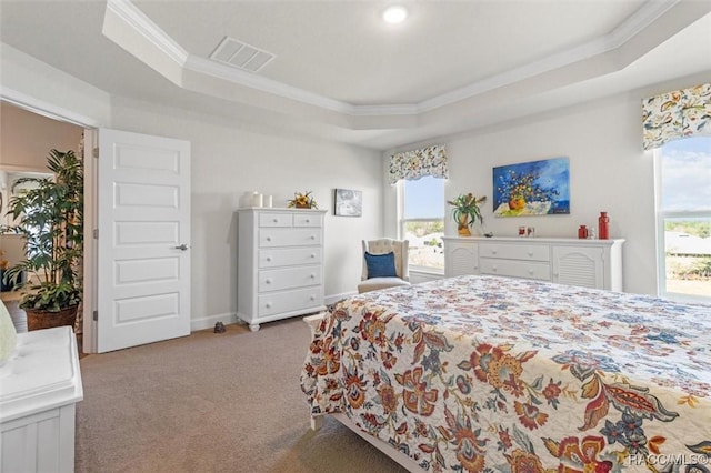 carpeted bedroom featuring a tray ceiling, baseboards, visible vents, and ornamental molding