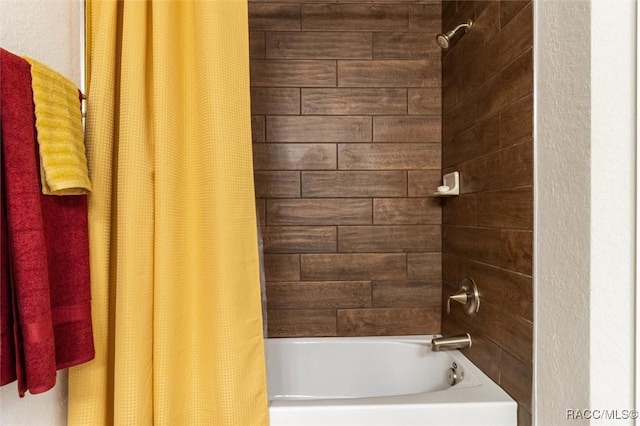 bathroom with shower / bath combo with shower curtain