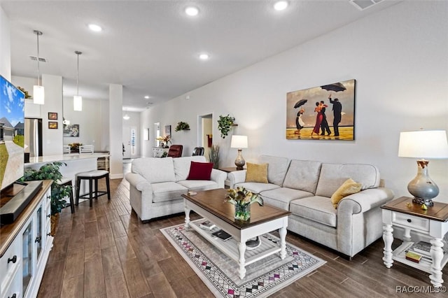 living room featuring recessed lighting, visible vents, and dark wood-type flooring