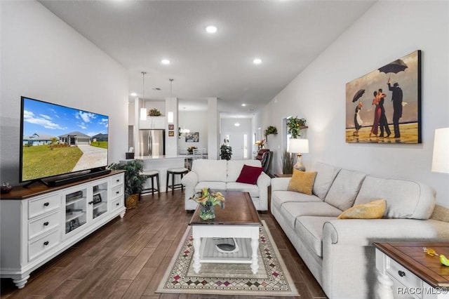 living room with dark wood-type flooring and recessed lighting