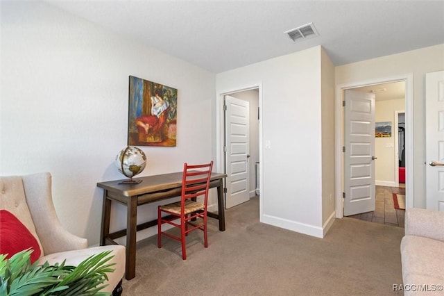 office space featuring visible vents, baseboards, and carpet