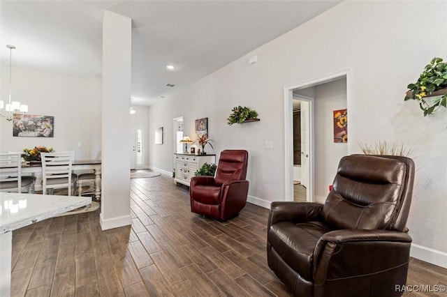 living area featuring a notable chandelier, visible vents, dark wood-type flooring, and baseboards