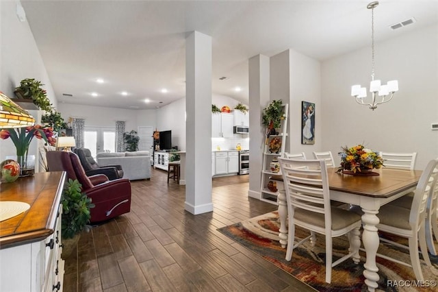 dining area with recessed lighting, visible vents, dark wood-type flooring, and an inviting chandelier