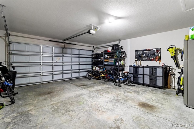 garage with a garage door opener and freestanding refrigerator