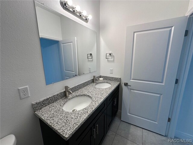 bathroom with tile patterned floors and vanity