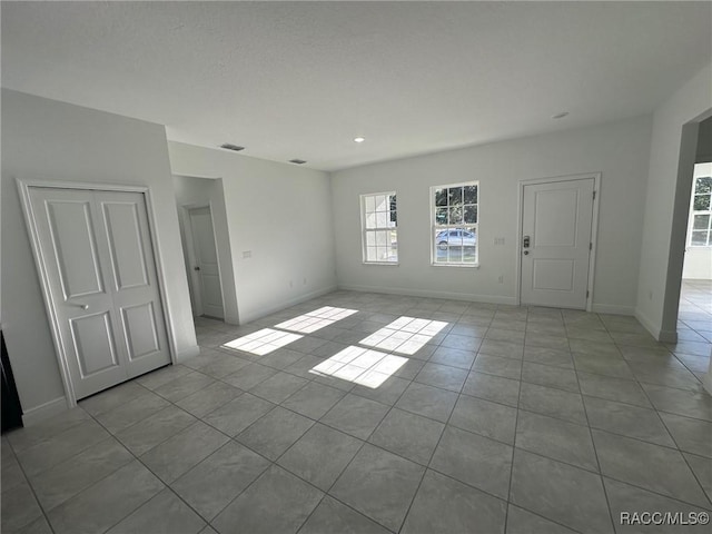 unfurnished room with light tile patterned floors