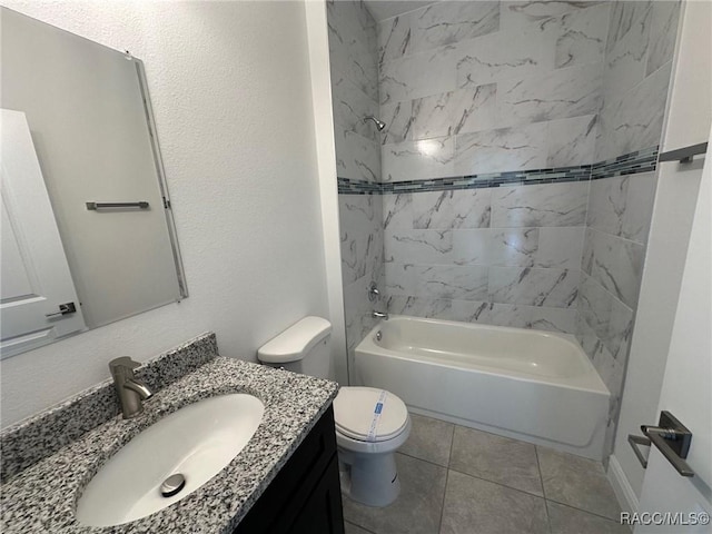 full bathroom featuring vanity, tiled shower / bath combo, toilet, and tile patterned flooring