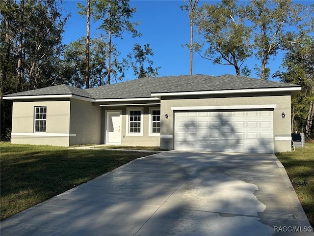 single story home with a garage and a front lawn