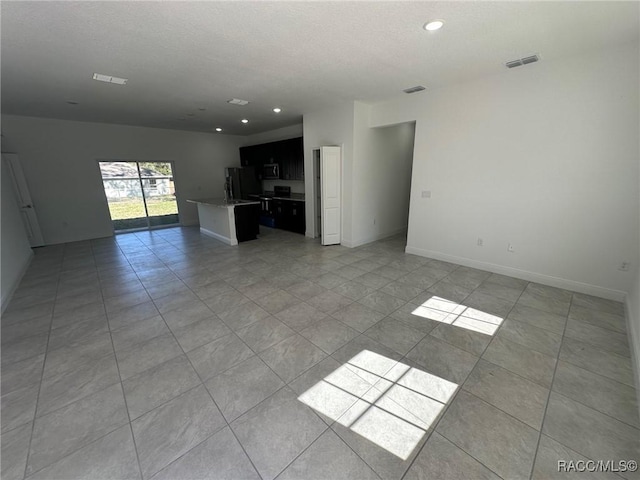 unfurnished living room featuring light tile patterned floors