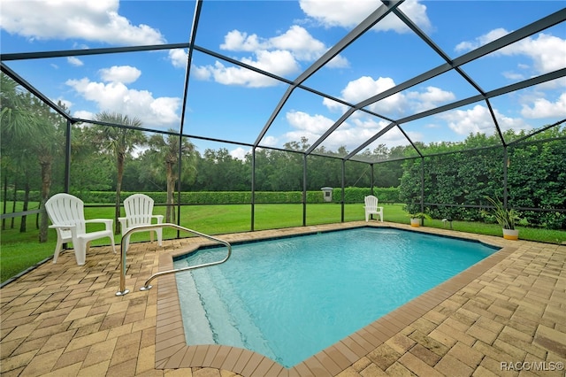 outdoor pool with a patio area, a lawn, and a lanai