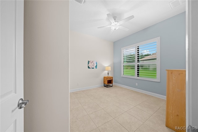 spare room featuring ceiling fan and light tile patterned flooring