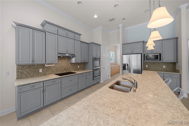 kitchen with appliances with stainless steel finishes, crown molding, sink, light tile patterned floors, and decorative light fixtures