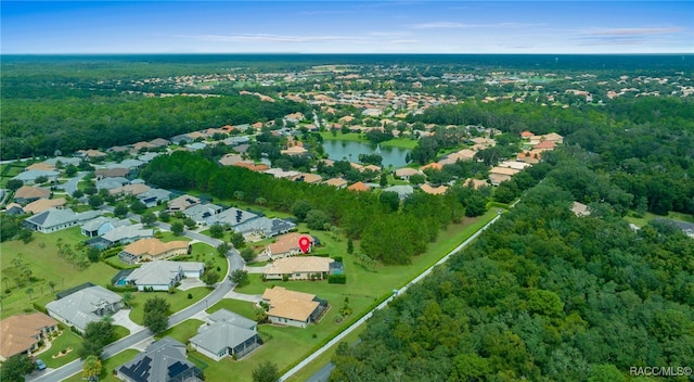 bird's eye view with a residential view, a wooded view, and a water view