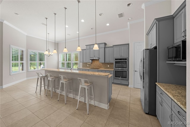 kitchen featuring light tile patterned flooring, visible vents, gray cabinets, and appliances with stainless steel finishes